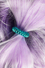 Elastic band on violet hair