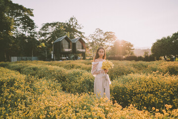 Young attractive woman having fun in yellow flower field