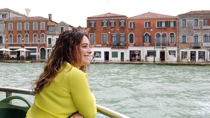 Fototapeta na wymiar Lady woman tourist by boat ferry watch the beauty of the city of the city of love in the Grand Canal Venice