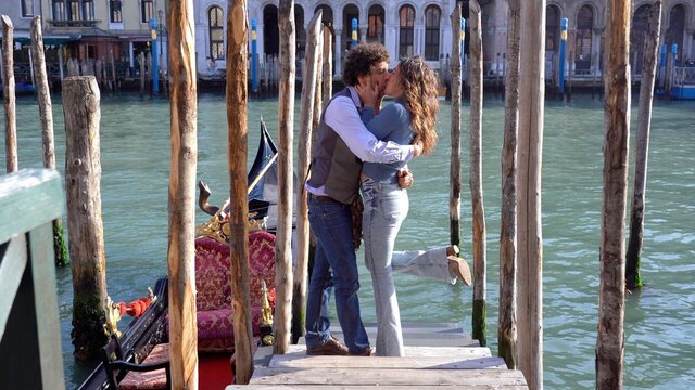 40-year-old man makes a marriage wedding proposal to his girlfriend by giving an engagement ring and kisses in Venice, the city of love, near the Rialto bridge - request to get married