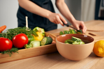 woman in apron cuts vegetables healthy food lifestyle