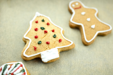 Biscuits. Christmas cookies on baking paper, decorated tree. Freshly baked cookies for the holiday. Close-up.