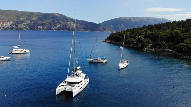 Luxury Boats And Yachts Anchored At The Crystal Blue Waters Of Foki Beach In Kefalonia, Greece. aerial