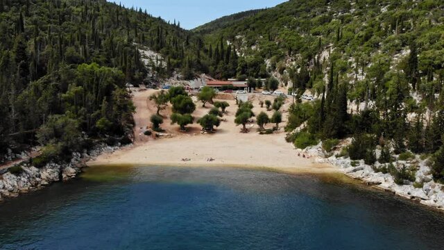Vehicle Parked At Small Tavern In Foki Beach, Kefalonia, Greece. aerial, pullback