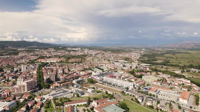 Aerial High view over City of Chaves Sprawling in distance, Cloudy day - Portugal