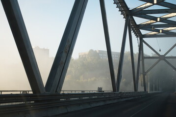 Automobile bridge in the morning fog