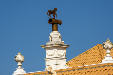 Fototapeta na wymiar chimney and weather vane on the roof of a palace in Estoi district of Faro, Algarve, Portugal