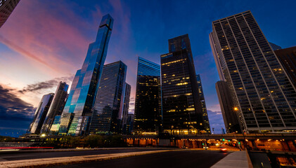 Early morning view of skyscraper glass facades reflecting the blue and pink sky at sunrise, downtown Chicago, IL, USA