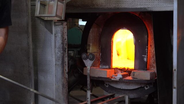 Murano, Venice,Italy November 2021 : Making famous Venetian glass in Murano, glass making - actual process inside the factory in Venice - the workshop master works by hand and blows the glass