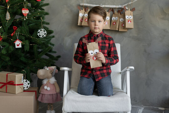 Happy Little Boy Holding Packages Of Sweets Advent Calendar, Christmas Kids Fun, Child At Home Waiting For The Holiday, Concept Kids Advent Calendar