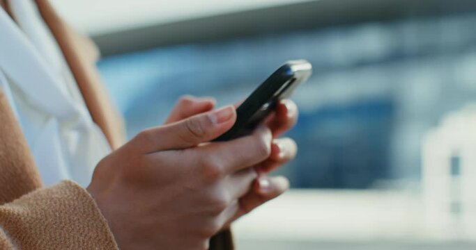 African American woman uses a mobile phone outdoors