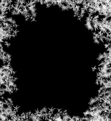 A frame of a frosty pattern of ice crystals on a black background. A frame with an abstract ice...