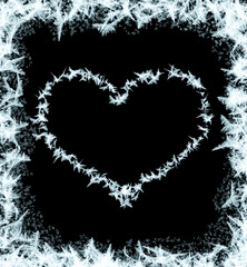 Frosty heart-shaped pattern of ice crystals on a black background. A dark surface with an ice structure allows you to apply or add a frost effect. Heart of frost on glass, freezing effect