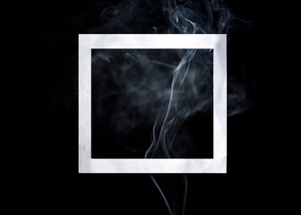 Empty photo frame with smoke on black background. Dark surreal concept with picture frame layout. Trendy minimal template with space for text.