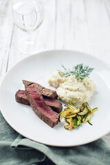 Beef steak on cauliflower puree with zucchini vegetables (low carb)