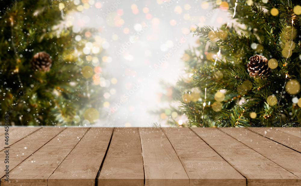 Wall mural empty christmas table background with christmas tree out of focus for product display montage.