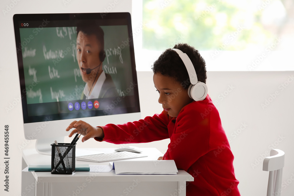 Poster little african-american boy studying online at home