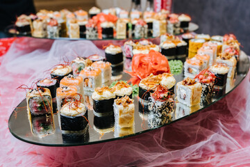 Assorted sushi nigiri and maki big set on mirrow plate.Sushi and sushi roll set, sushi rolls served with wasabi and ginger