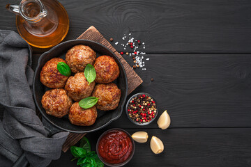 Meatballs with sauce, spices and in a frying pan.