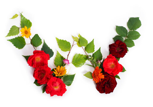 Floral summer font. Concept alphabet design, letter W. Seasonal decorative beautiful type mades of different multi-colored blooming flowers and grass. Natural summertime print