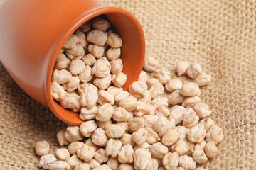 Dry chickpea in bowl on wooden background.