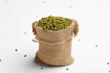 Green gram or mung bean in bag over white background.