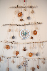 Handmade craft Christmas tree from sticks and natural materials.