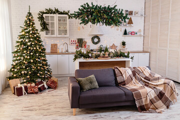 Christmas decorations in a cozy home with a white kitchen on New Year's Eve. Christmas atmosphere