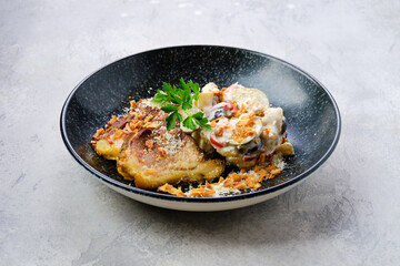 Pickled cucumber with boiled potato and olives served with fried pork belly slices