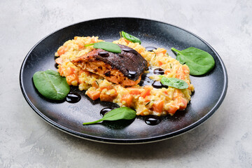 Fried salmon steak served with bulgur and sweet potato