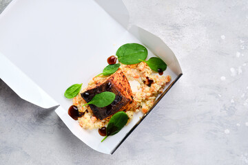 Fried salmon steak served with bulgur and sweet potato