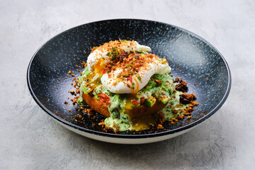Poached egg on a bun with avocado