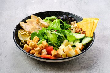 Bowl with salad mix and various snacks
