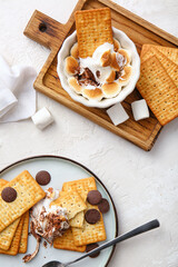 Composition with tasty S'mores dip and crackers on white background