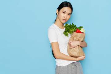 young woman with a package of products on a blue background diet calories healthy lifestyle