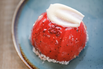 red strawberry cake on blue plate