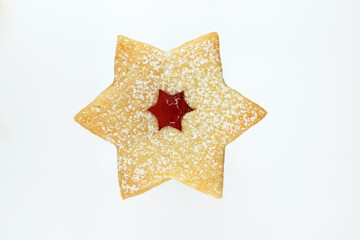 Linzer cookie in a shape of star filled with strawberry jam