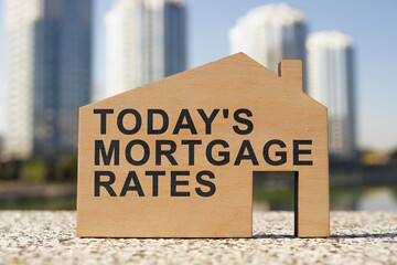 Todays mortgage rates phrase on the small wooden home.