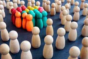 Social inclusion concept. Group color figurines and wooden ones.