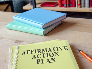 Affirmative Action Plan AAP with other papers on the desk.