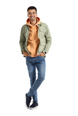 Naklejka premium Young man in stylish hoodie and jacket on white background