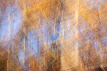 Abstract waves of autumn colors and blue sky