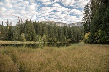 autumn Nizke Tatry mountains scenery with Vrbicke pleso lake and peaks above in Slovakia