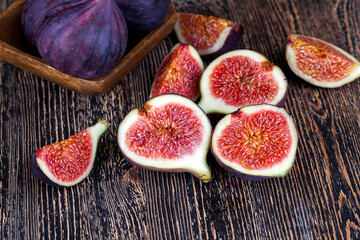 ripe purple figs on a wooden table
