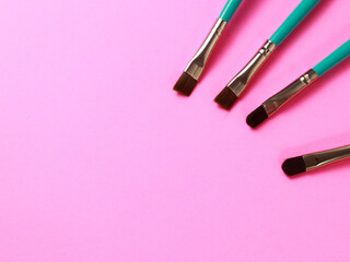 makeup brush for face shading eyes on pink background