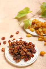 Stand with tasty raisins on color background