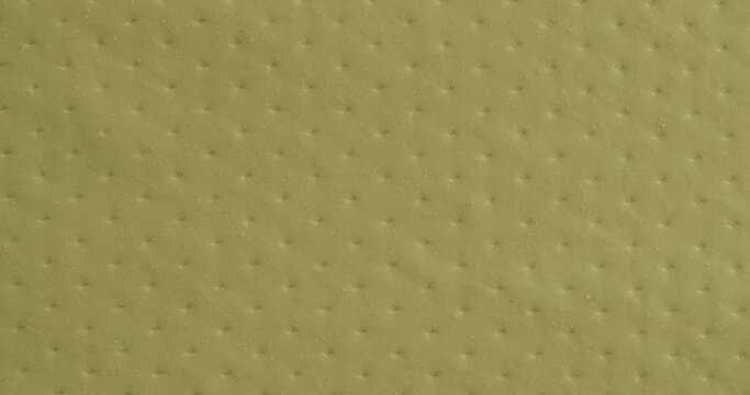 The texture of polyethylene close-up. Yellow background.