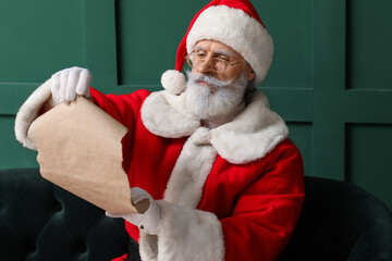 Santa Claus reading wish list at home on Christmas eve