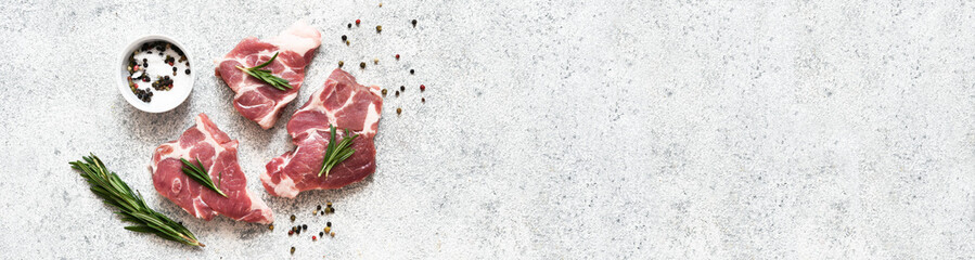 Fresh meat. Food delivery. Beef with salt and rosemary on a concrete background, top view.