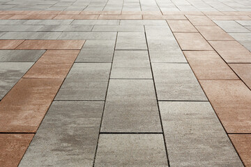 Creation of markings on the sidewalk from slabs of different colors. Selective focusing.